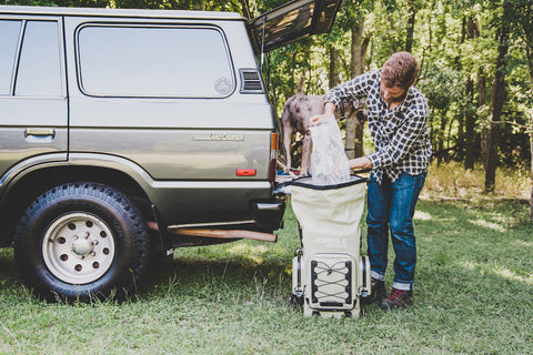 A person packs their IceMule cooler as they prep for their next trip.