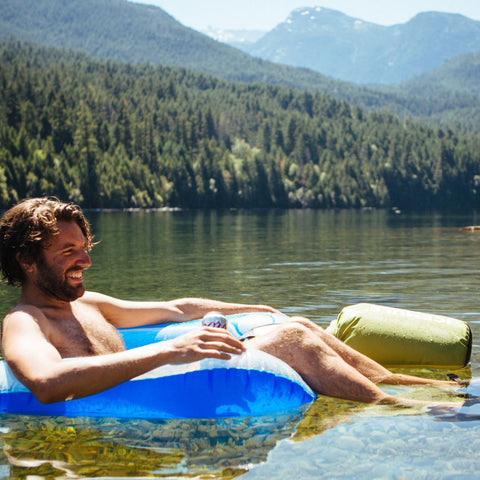 man on float with icemule floating next to him